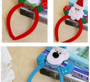 Detailed close-up of festive plush Christmas headbands with Santa and snowman motifs