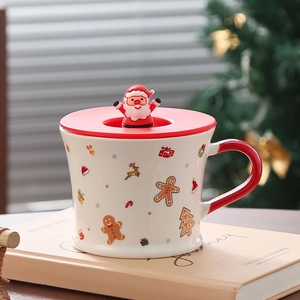 Close-up of white ceramic Christmas mug with 3D Santa lid and red handle details