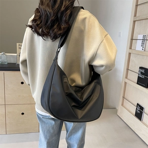 Black nylon dumpling bag with large capacity and wide shoulder strap for women