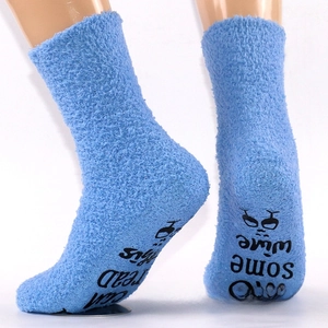 Detail of blue coral fleece socks with anti-slip wine letters on the bottom sole