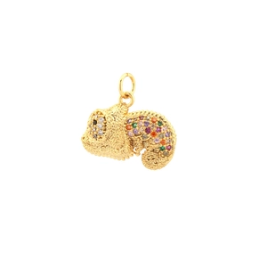 Close-up of a gold chameleon pendant with colorful stones and delicate metal loop