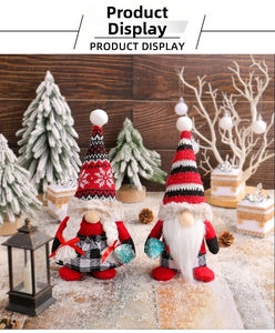 Close-up of plush Christmas gnomes with striped hats and snowflake embroidery detail