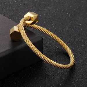 Detailed view of golden twisted steel wire bracelet with hexagon nut end design