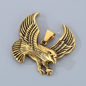 Detailed macro view of gold eagle pendant with intricate feather textures and shiny finish