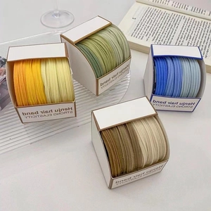 Detail of colorful gradient seamless elastic hair ties in minimalist window boxes
