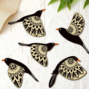 Set of 5 wooden hummingbird wall art pieces with ethnic patterns on white brick wall