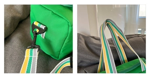 Detail of green canvas sports bag featuring striped shoulder strap and plastic buckles