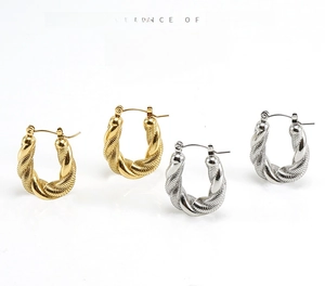Detailed view of twisted U-shaped hoop earrings in gold and silver stainless steel