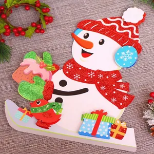 Glittering Christmas snowman desktop ornament with colorful gift boxes on festive tablecloth