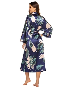 Back view of a long navy satin robe with tropical leaf print and elegant drape