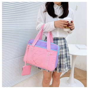 Detail of pink and purple JK uniform itabag with a heart-shaped window and coin purse