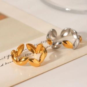 Polished irregular wheat bean rings in gold and silver on vintage paper background