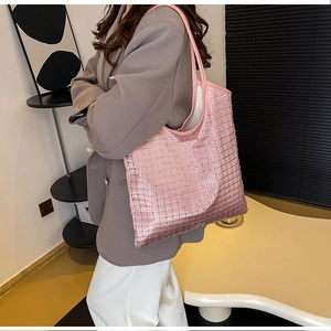 Pink satin tote bag with sparkling crystal grid pattern shown over the shoulder