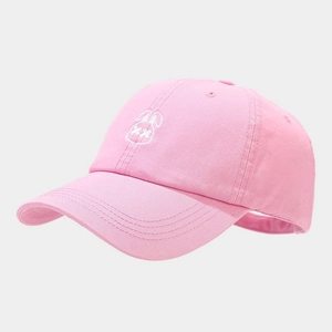 Detail of pink cotton baseball cap featuring minimalist white bunny embroidery on front