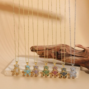 Macro detail of 14K gold plated bear pendants with colorful cubic zirconia stones