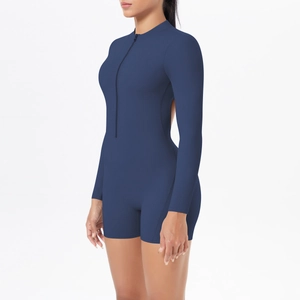 Detail view of navy blue backless athletic jumpsuit with front zipper and long sleeves