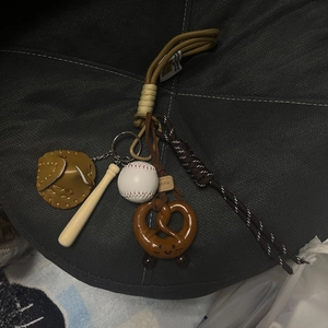 Mini baseball set keychain with wood bat, leather glove, and pretzel bag charm detail