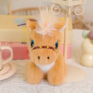 Detail of cute plush pony with soft brown fur, blue embroidered eyes and golden mane hair