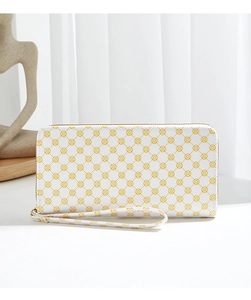 Detailed view of the white PU long wallet with yellow floral patterns and wrist strap