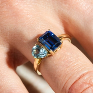 Titanium steel ring with rectangular dark blue and pear-shaped light blue zircons