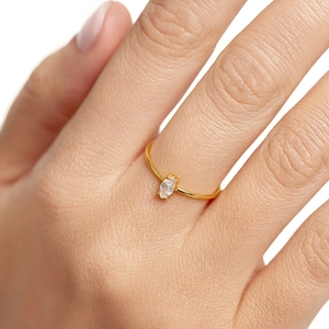 Close-up of thin 18k gold plated ring featuring a marquise-cut sparkling zircon stone