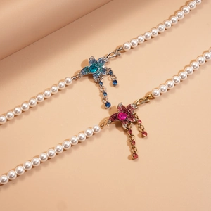 Elegant beaded pearl necklace with rhinestone starfish charms and fringe details