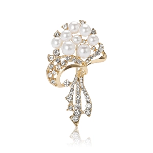 Elegant gold flower bouquet brooch with white pearls and rhinestones on white background