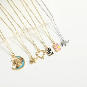 Detail view of assorted baroque charms including elephant, unicorn, and heart necklaces
