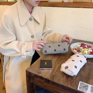 Close-up of corduroy makeup bags with polka dots and high-quality metal zippers