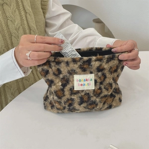 Detail of leopard print plush makeup bag showing soft texture and spacious inner storage