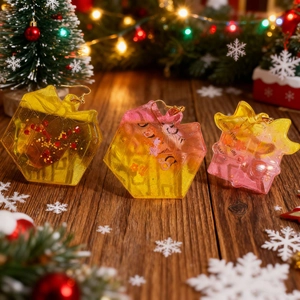 Christmas gift box resin earrings with glitter and cat motif on wooden background