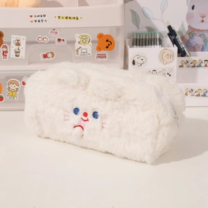 Close-up of white plush pencil case featuring cute cat embroidery and soft fuzzy texture