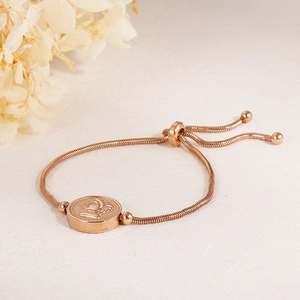 Detail of rose gold adjustable queen coin bracelet with snake chain and portrait pendant
