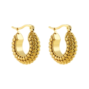 Detailed view of gold granulated textured latch back earrings with vintage hollow design