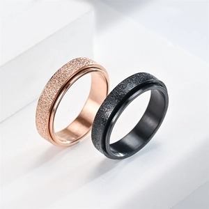 Matching rose gold and black 6mm titanium rings with frosted sand finish for couples