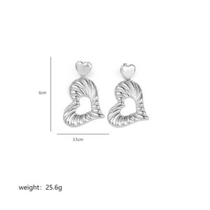 Detailed view of silver heart-shaped drop earrings showing size dimensions and weight