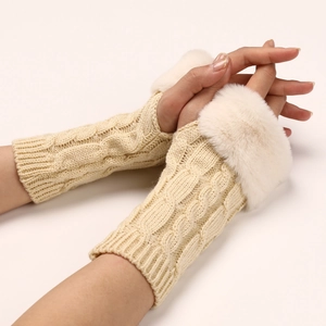 Detail of cable knit fingerless gloves with plush faux fur trim in cream beige