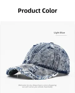 Close-up of frayed edges and distressed details on light blue washed denim baseball cap