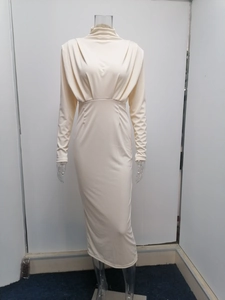 Close-up of cream white long sleeve turtleneck dress with elegant pleated waist detail