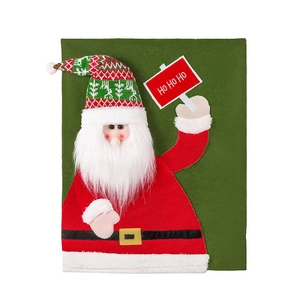 Festive Santa Claus chair cover in red and green with plush beard and HO HO HO sign