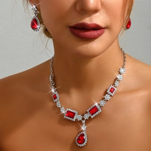 Macro detail of elegant red square and teardrop gemstone necklace set on model