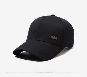 Detail view of cotton baseball cap featuring a bronze sports style mountain metal logo