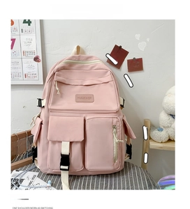 Pink multi-pocket backpack with adjustable black buckles and high-capacity nylon compartments