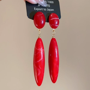 Elegant red marble drop earrings with gold metal links and long tapered pendants