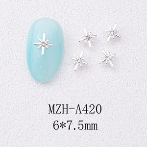 Macro shot of 6x7.5mm silver star nail charms with crystal on a light blue nail