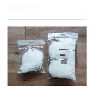 Macro detail of elastic white mesh sink strainer bags in 100 piece bulk packaging