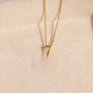 Macro detail of gold-plated evil eye pendant with light blue enamel and O-chain texture