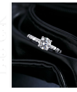 Macro view of a 1-carat moissanite ring with four-prong setting and twisted diamond band