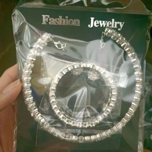 Detail of silver rhinestone necklace and earring set in Fashion Jewelry packaging