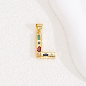 Detailed macro view of gold-plated L-letter pendant with vibrant colorful zircon stones